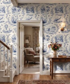Bookish blue toile wallpaper in a hallway beside a white staircase and open doorway