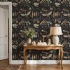 Dark academia wallpaper behind a carved wooden console table with a linen lamp