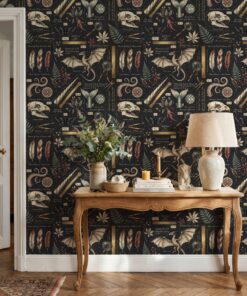 Dark academia wallpaper behind a carved wooden console table with a linen lamp