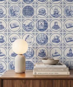 Delft tile wallpaper close-up with blue medallions showing a reader in an armchair, a library ladder, a sleeping cat, a tall ship and a whale