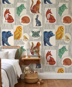 Folk art animal wallpaper in a kids bedroom with a wooden spindle bed and floating nightstand