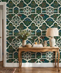 Green Mughal garden wallpaper behind a carved wooden console table with a linen lamp