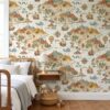 Kids map wallpaper with islands, mountains and compass roses in a bedroom with a wooden spindle bed
