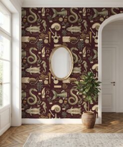 Maroon mermaid wallpaper in an entryway with a gold oval mirror and arched doorway