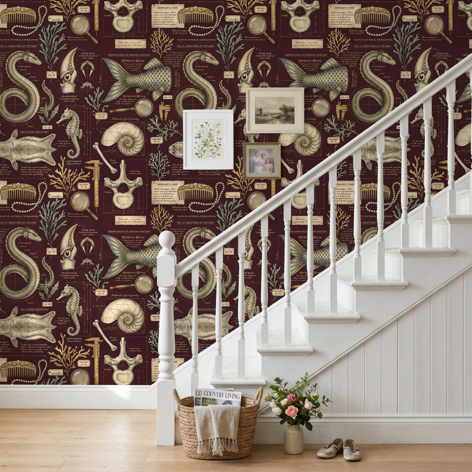 Maroon dark academia sea creature wallpaper on a staircase wall with a white banister