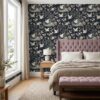 Chinoiserie crane wallpaper in navy behind a mauve tufted headboard in a bedroom