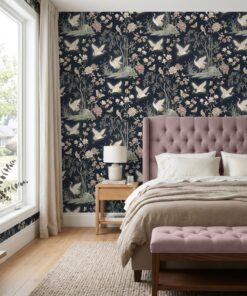 Chinoiserie crane wallpaper in navy behind a mauve tufted headboard in a bedroom