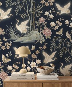 Close-up of navy chinoiserie wallpaper with white cranes, blush peonies, magnolias, bamboo and gold moths