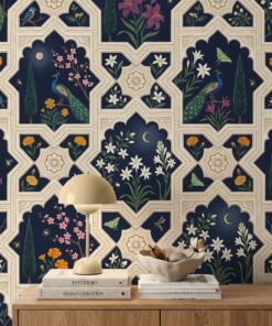 Close-up of navy Mughal wallpaper with peacocks, kingfishers, magenta lilies, jasmine, cypress trees and a gold moon in carved ivory arches
