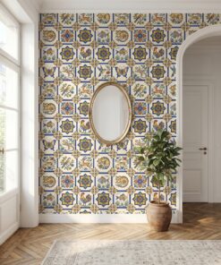 Colorful animal azulejo Spanish tile wallpaper in an entryway with a gold oval mirror and arched doorway