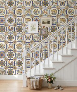 Spanish tile wallpaper with cats, hares and fish on a staircase wall with a white banister